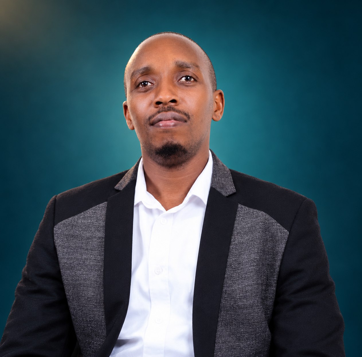 Mr Julius Eddy Ruhweza, Director of VSMART Driving School, on a deep teal background